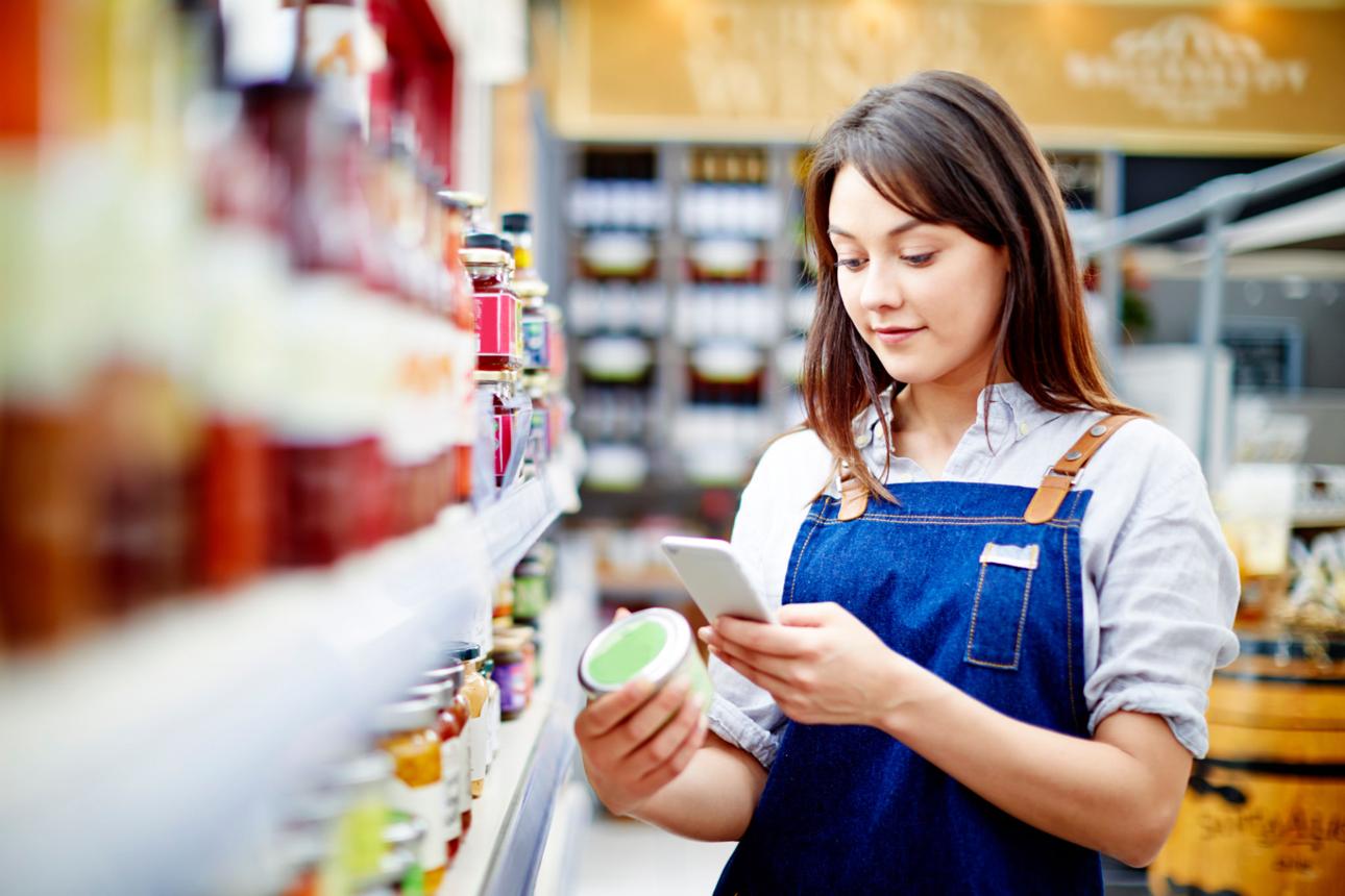 Store colleague scanning a shelf product with a mobile app